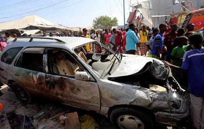 Civilians stand near a car destroyed in a suicide bomb explosion at the Wadajir market in Madina district of Somalia's capital Mogadishu, February 19, 2017. Picture:REUTERS