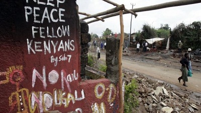 Kenyans walk past a destroyed house in the sprawling Kibera slums, which was one of the most affected areas during the post-election violence in 2007. Picture:REUTERS