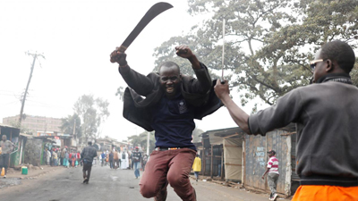 A supporter of opposition leader Raila Odinga gestures with a machete in Kibera slum in Nairobi Picture:REUTERS