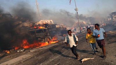 Civilians evacuate from the scene of an explosion in KM4 street in the Hodan district of Mogadishu. Picture:REUTERS
