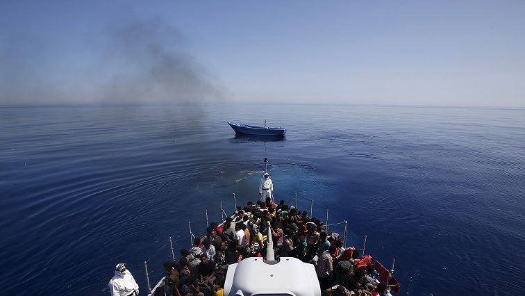 talian police carry migrants to safety, leaving their leaky boat to drift. REUTERS/Alessandro Bianchi