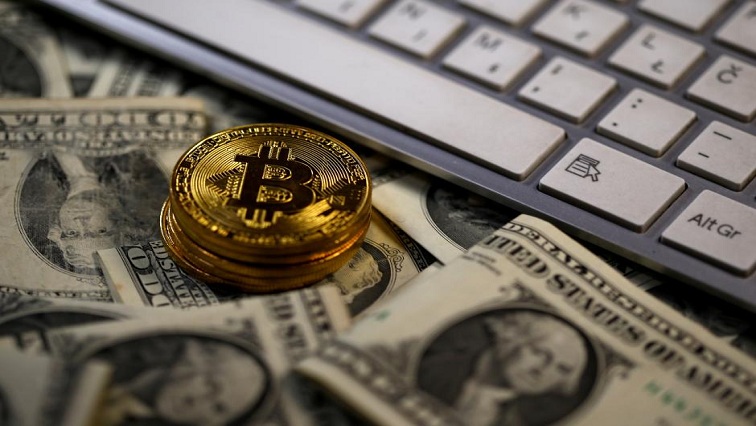 FILE PHOTO: Bitcoin (virtual currency) coins placed on Dollar banknotes, next to computer keyboard, are seen in this illustration picture, November 6, 2017.  REUTERS/Dado Ruvic/Illustration/File Photo