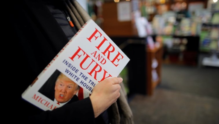 A woman holds a copy of "Fire and Fury: Inside the Trump White House" by Michael Wolff at a book store in Washington, DC. REUTERS/Carlos Barria