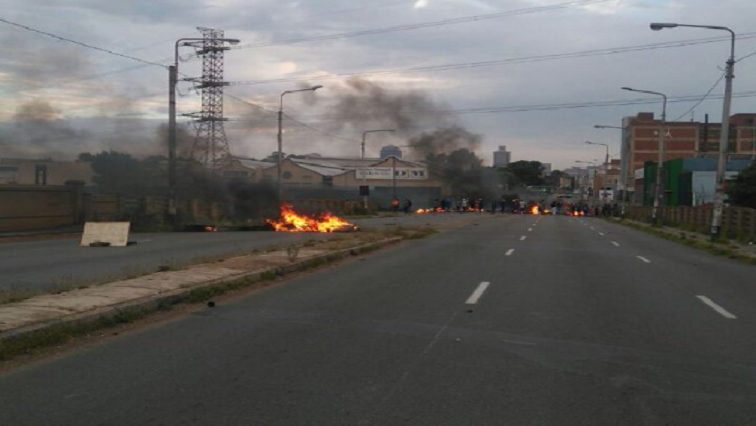 Protesting residents brought traffic to a standstill on Ellof Street in the morning, blockading the road with burning tyres and rocks.