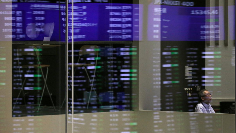 Market prices are reflected in a glass window at the Tokyo Stock Exchange (TSE) in Tokyo, Japan.