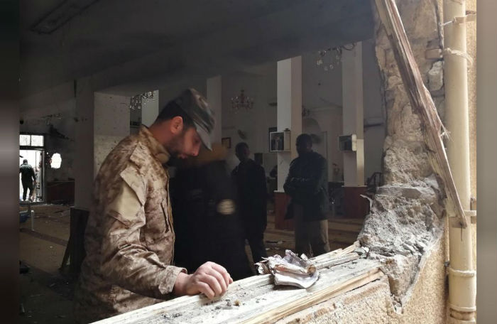 A member of the Libyan National Army inspects the damage following a twin bombing inside a mosque in Benghazi, Libya.