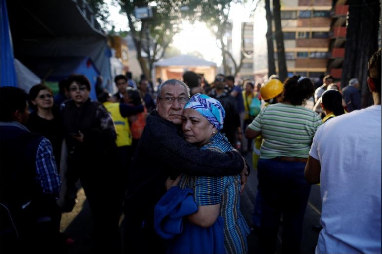 People react after an earthquake shook buildings in Mexico City, Mexico February 16, 2018.