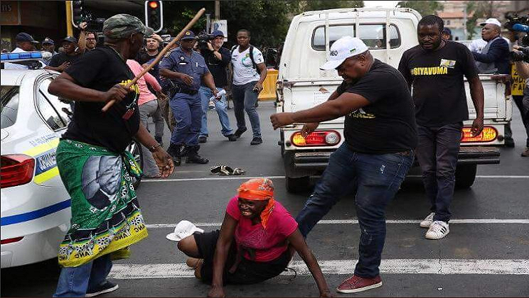 An ANC member is seen kicking a woman outside Luthuli House.