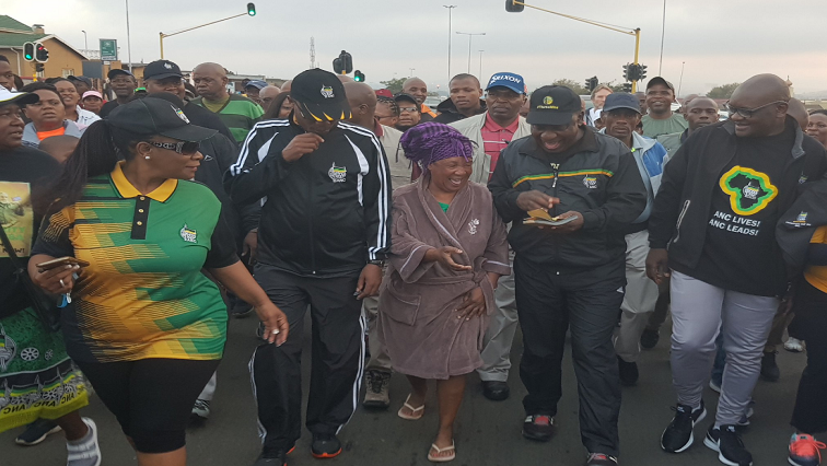 President Cyril Ramaphosa walks alongside community members in Soweto.