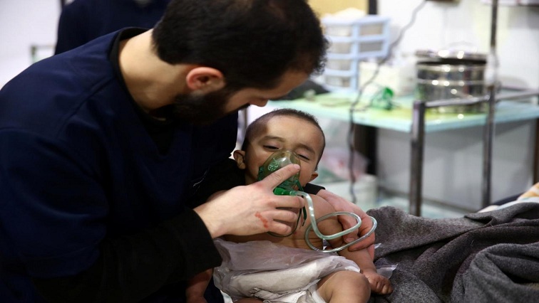 Man with a child are seen in hospital in the besieged town of Douma, Eastern Ghouta, Damascus, Syria.