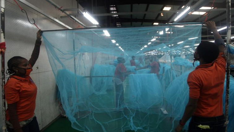 Workers look for abnormal holes in mosquito netting at the A to Z Textile Mills factory producing insecticide-treated bed nets in Arusha, Tanzania, May 10 2016.