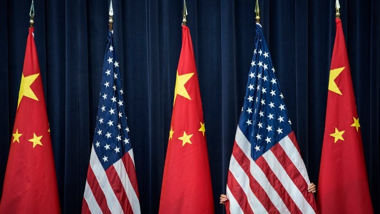 (FILES) In this file photo taken on July 10, 2013, a staff member adjusts a USn flag before the opening session of the US and China Strategic and Economic Dialogue at the US Department of State in Washington, DC.  
The White House said on May 29, 2018