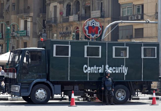 An Egyptian riot police officer is seen outside El Sadat metro station at Tahrir square in the center of Cairo, Egypt.