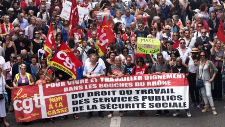 People hold a CGT trade union banner during a "maree populaire" (working-class tide) demonstration called by political organisations, associations and unions to protest against French President's policy