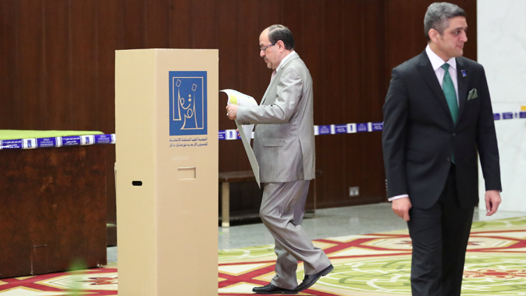 Iraqi Vice President and former Prime Minister Nuri al-Maliki attends to cast his vote at a polling station during the parliamentary election in Baghdad.