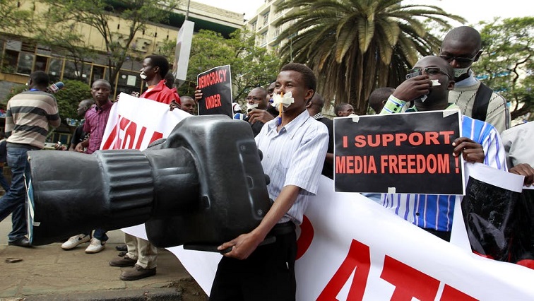 File photo: A Kenyan journalist carries a plastic replica of a camera as he participates in a protest along the streets of the capital Nairobi, 3 December 2013.