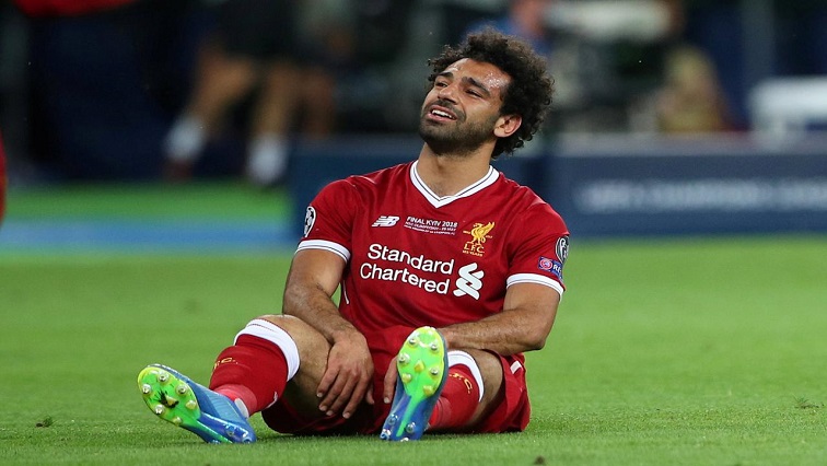 Liverpool's Mohamed Salah looks dejected after sustaining an injury.