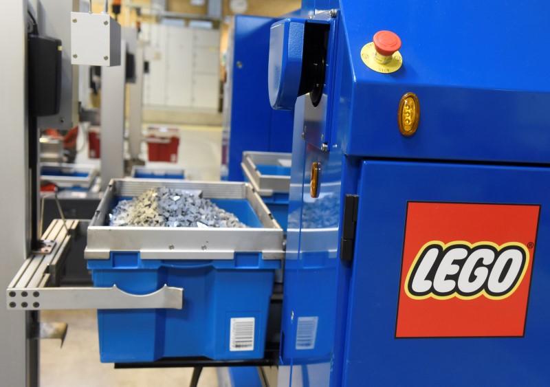 A robot picks up Lego bricks in a production line at the factory of Danish toy company Lego in Billund, March 1, 2016.