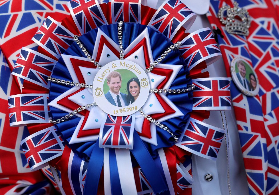 A royal fan wears a Prince Harry and Meghan Markle Union Jack rosette at Windsor Castle.
