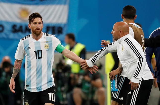 Argentina's Lionel Messi celebrates their second goal with coach Jorge Sampaoli .