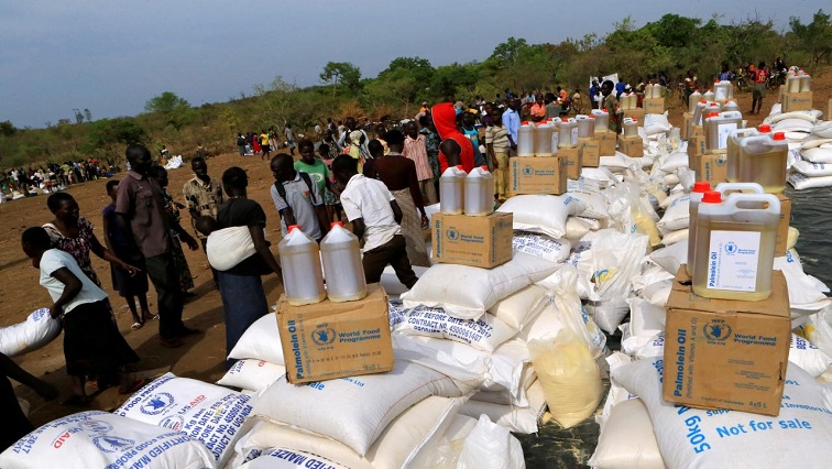FILE PHOTO: South Sudanese refugees displaced by fighting, receive food rations in Imvepi settlement in Arua district, northern Uganda, April 4, 2017. REUTERS/James Akena/File photo