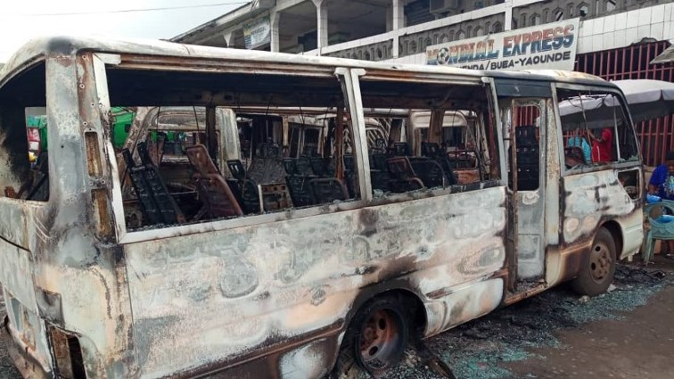 A picture taken on July 10, 2018 shows burned busses at the bus terminal in Buea.