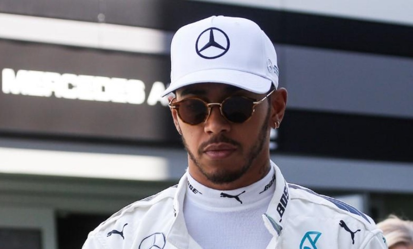 Mercedes Formula One driver Lewis Hamilton of Britain walks in the paddock area.