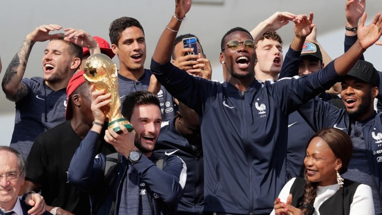 (Front row from L) French Football Federation president Noel Le Graet, France's goalkeeper Hugo Lloris with the trophy, French Sports Minister Laura Flessel, (back row from L) France's defender Lucas Hernandez, France's defender Benjamin Mendy, France's defender Raphael Varane, France's midfielder Paul Pogba, France's defender Benjamin Pavard and France's forward Thomas Lemar pose for pictures and celebrate upon their arrival at the Roissy-Charles de Gaulle airport on the outskirts of Paris, on July 16, 2018 after winning the Russia 2018 World Cup final football match.