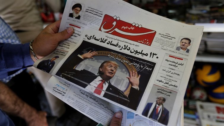 A man takes a glance at a newspaper with a picture of US president Donald Trump on the front page, in the capital Tehran on July 31, 2018.
Iran's currency traded at a fresh record-low of 119,000 to the dollar today, a loss of nearly two-thirds of its value since the start of the year as US sanctions loom. / AFP PHOTO / ATTA KENARE