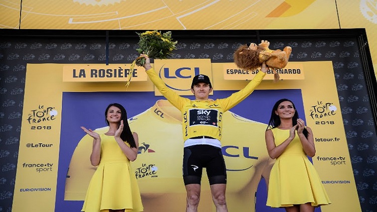 Great Britain's Geraint Thomas, wearing the overall leader's yellow jersey, celebrates on the podium after winning the eleventh stage of the 105th edition of the Tour de France cycling race between Albertville and La Rosiere, French Alps, on July 18, 2018.