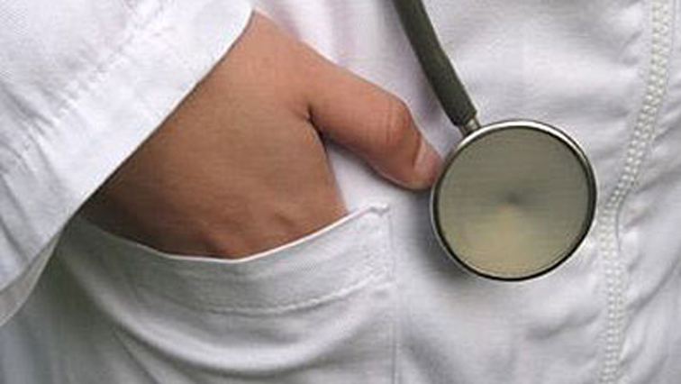 Doctor's hand and hanging stethoscope
