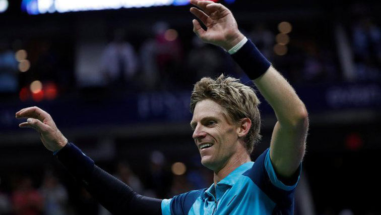 Kevin Anderson with arms in the air.