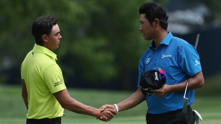 Rickie Fowler of the United States shakes hands with Hideki Matsuyama of Japan on the ninth green during the first round of the 2018 PGA Championship