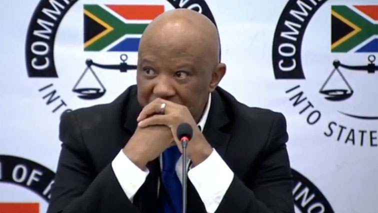 Mcebisi Jonas with hands clasped in front of his face