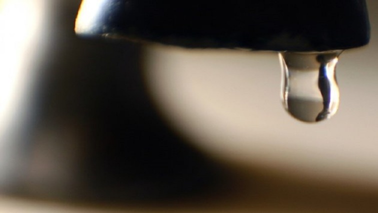 A water droplet dripping from a tap