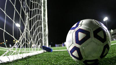 A soccer balll next to a net