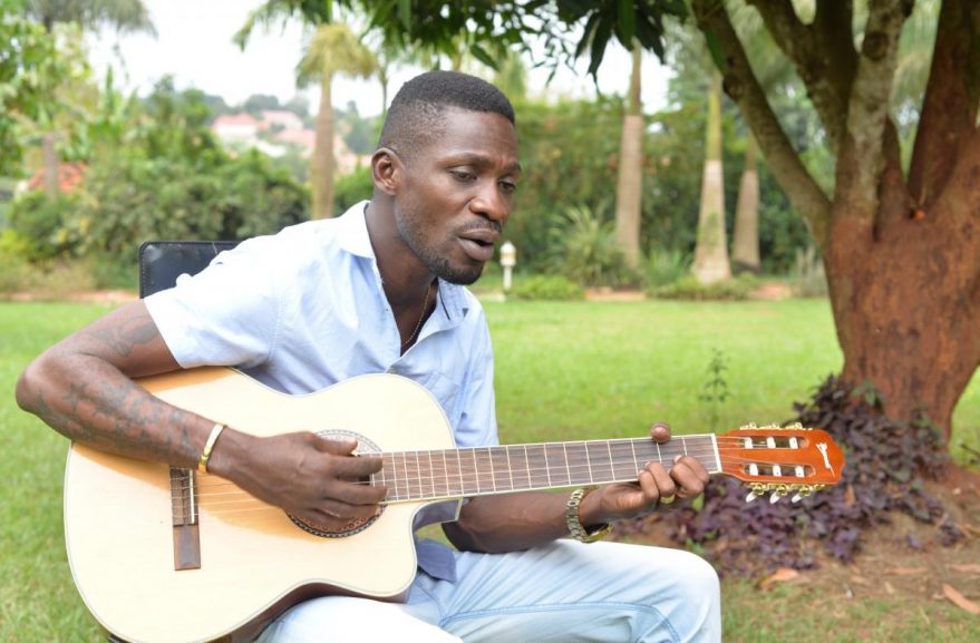 Bobi Kyagulani singing with his guitar