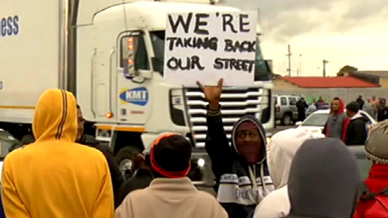 Protesters next to a truck