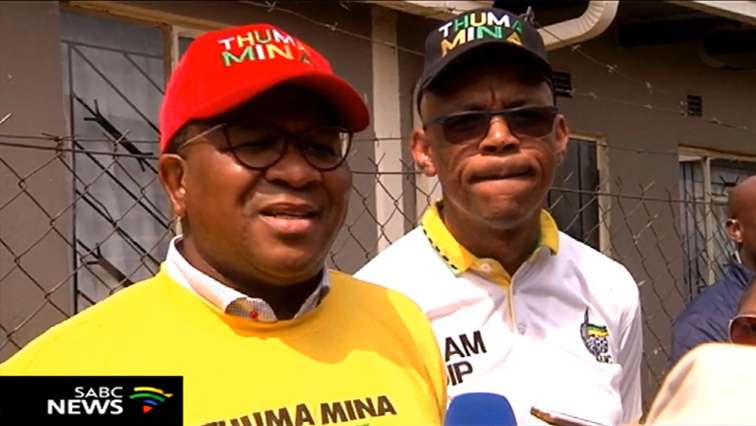 Fikile Mbalula wearing a red cap