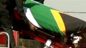 Coffin wrapped with South African flag