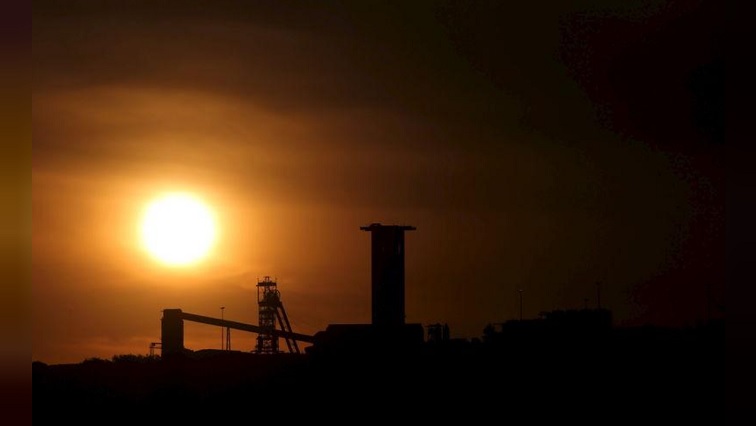 The sun sets behind a shaft outside the mining town of Carletonville, west of Johannesburg, July 7 2015.