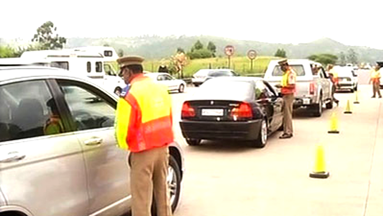 Officers and motorists at a roadblock
