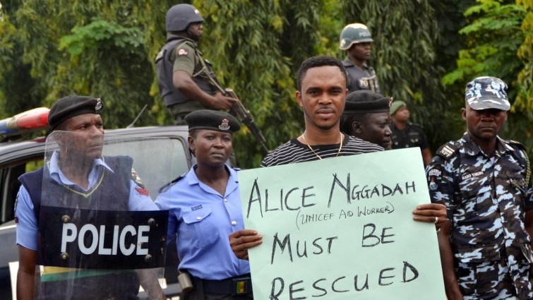 A man holds a placard reading "Alice Nggadah must be rescued", referring to Alice Loksha Nggadah who is one of the three female health workers kidnapped on March 1 by Boko Haram jihadists, during a protest.