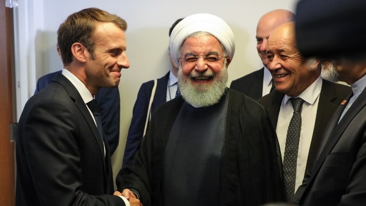 French President Emmanuel Macron (L) meets with Iranian President Hassan Rouhani (C), as French Foreign Minister Jean-Yves Le Drian (R) looks on
