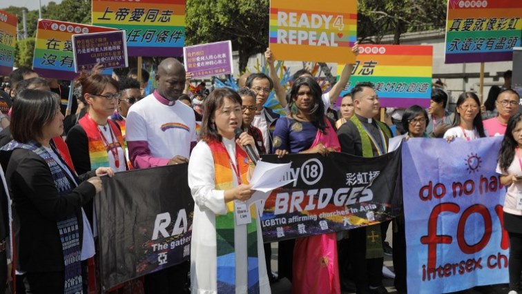 Members of a pro-gay Christian group assemble for the media before the start of a gay pride parade in Taipei on October 27.