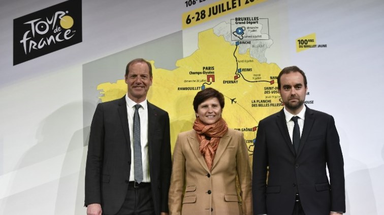 (From L) General Director of the Tour de France, France's Christian Prudhomme, French Sports Minister Roxana Maracineanu and French deputy minister attached to Relations with Local Territories Sebastien Lecornu pose for a photograph on stage during the presentation of the official route of the 2019 edition of the Tour de France cycling race.