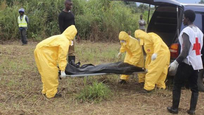 Health officials carrying a dead body of a person who died of Ebola.