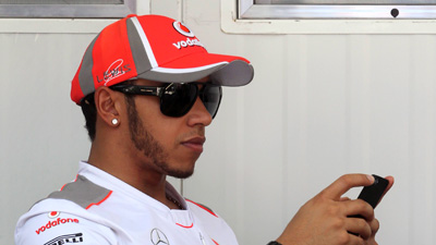 Lewis Hamilton on his mobile phone