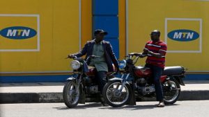 Men on motorbikes in front of MTN in Nigeria.