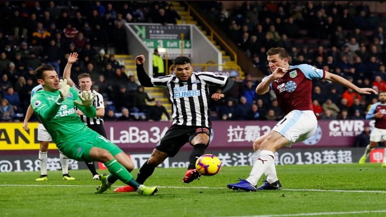 Newcastle United's Martin Dubravka and DeAndre Yedlin in action with Burnley's Chris Wood.